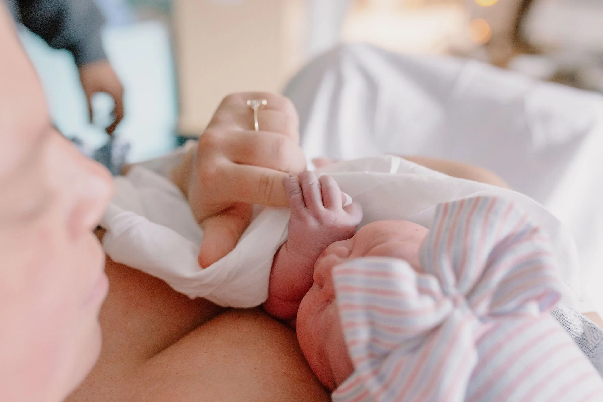 newborn baby holding mom finger in Gilbert Arizona birth photography