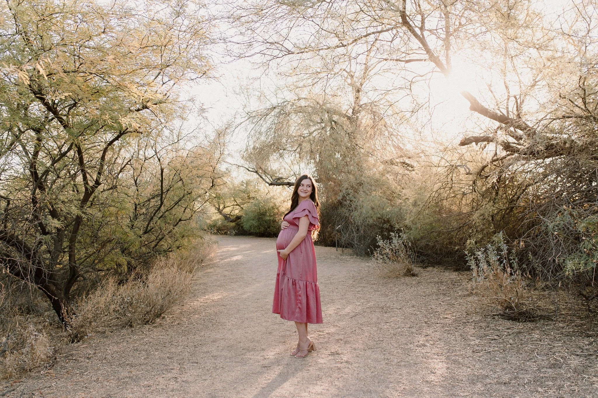 pregnant mom holding belly in desert maternity photoshoot Gilbert AZ