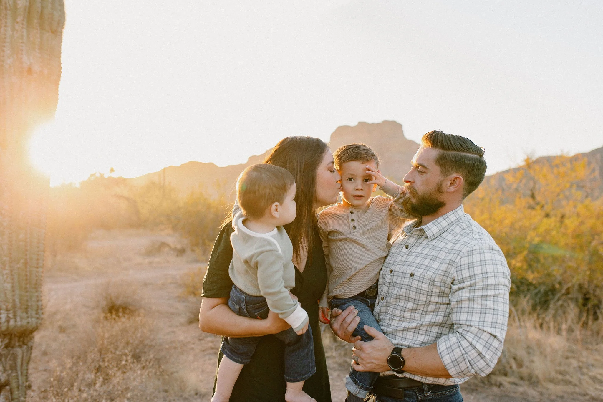 Family photographer captures mom kissing son in Arizona desert session