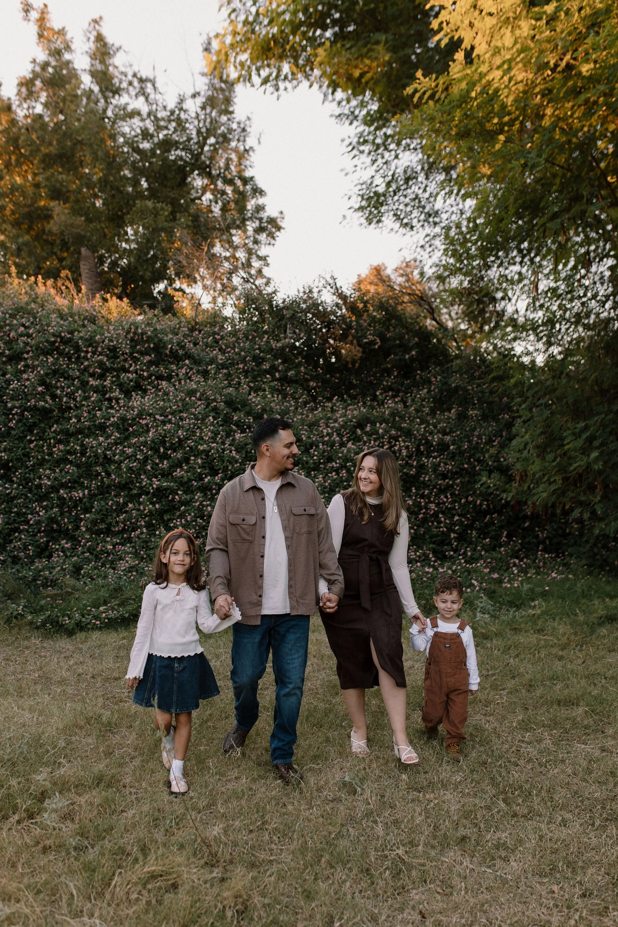 family photographer capture family walking through meadow in Mesa, Arizona