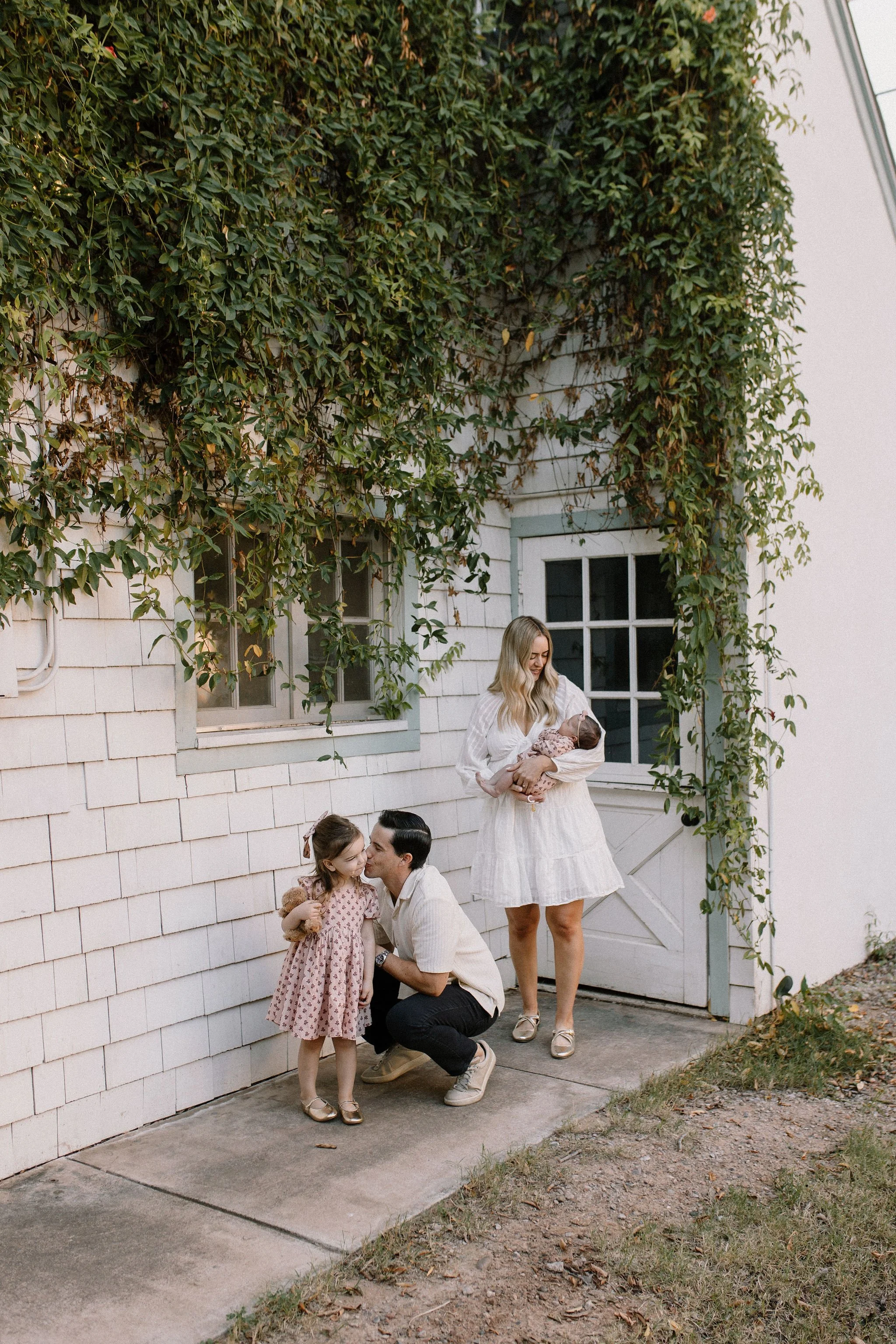 family photographer captures real moment in backyard garden with parents and daughters in Mesa, Arizona