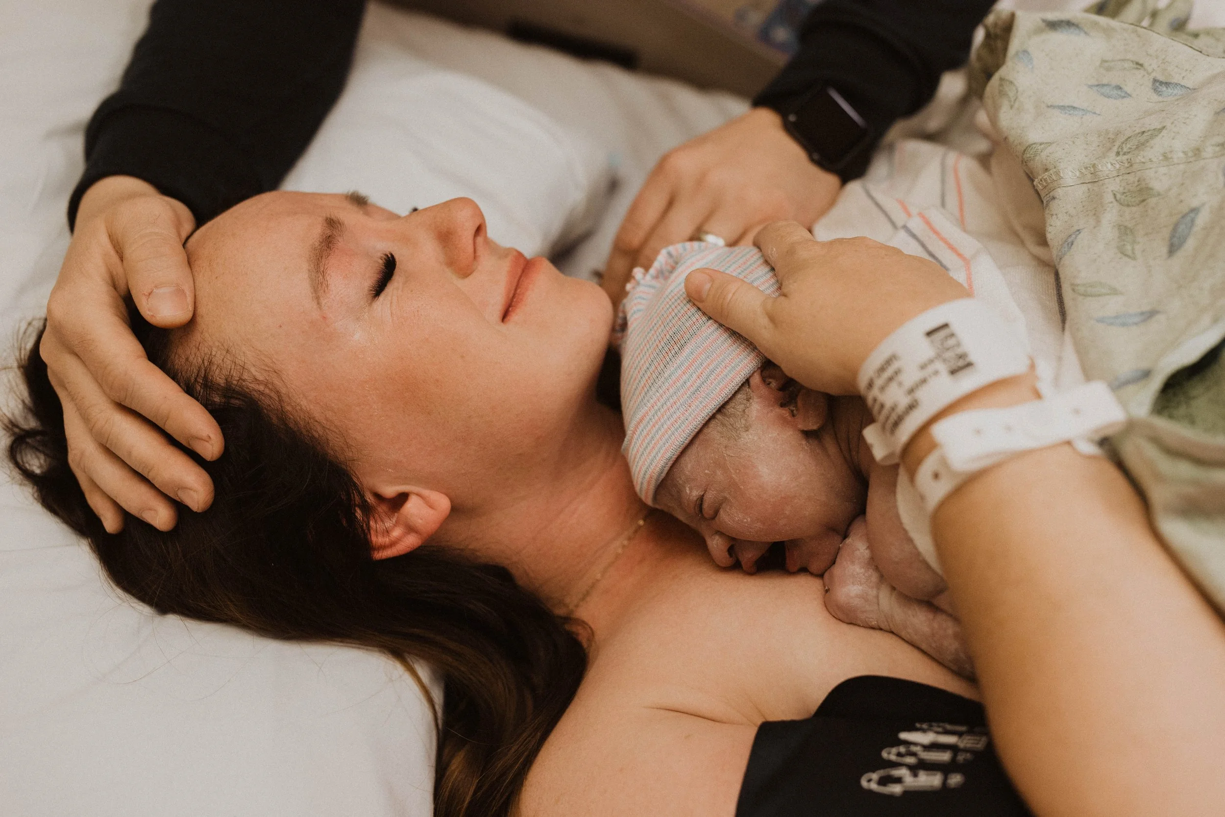 mom holding newborn baby in Arizona birth photography session