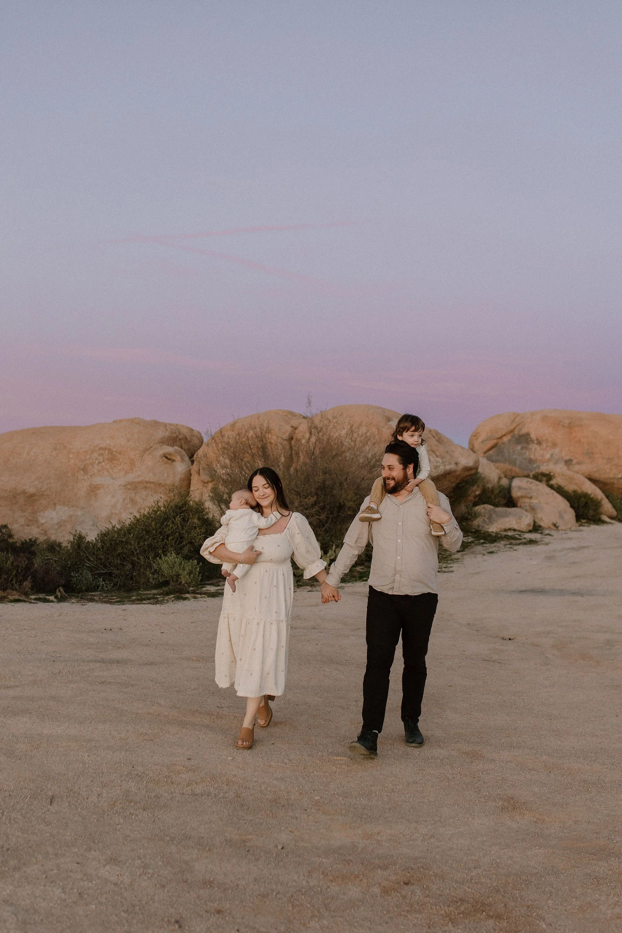 family photographer captures tender walking moment at blue hour in Arizona desert session