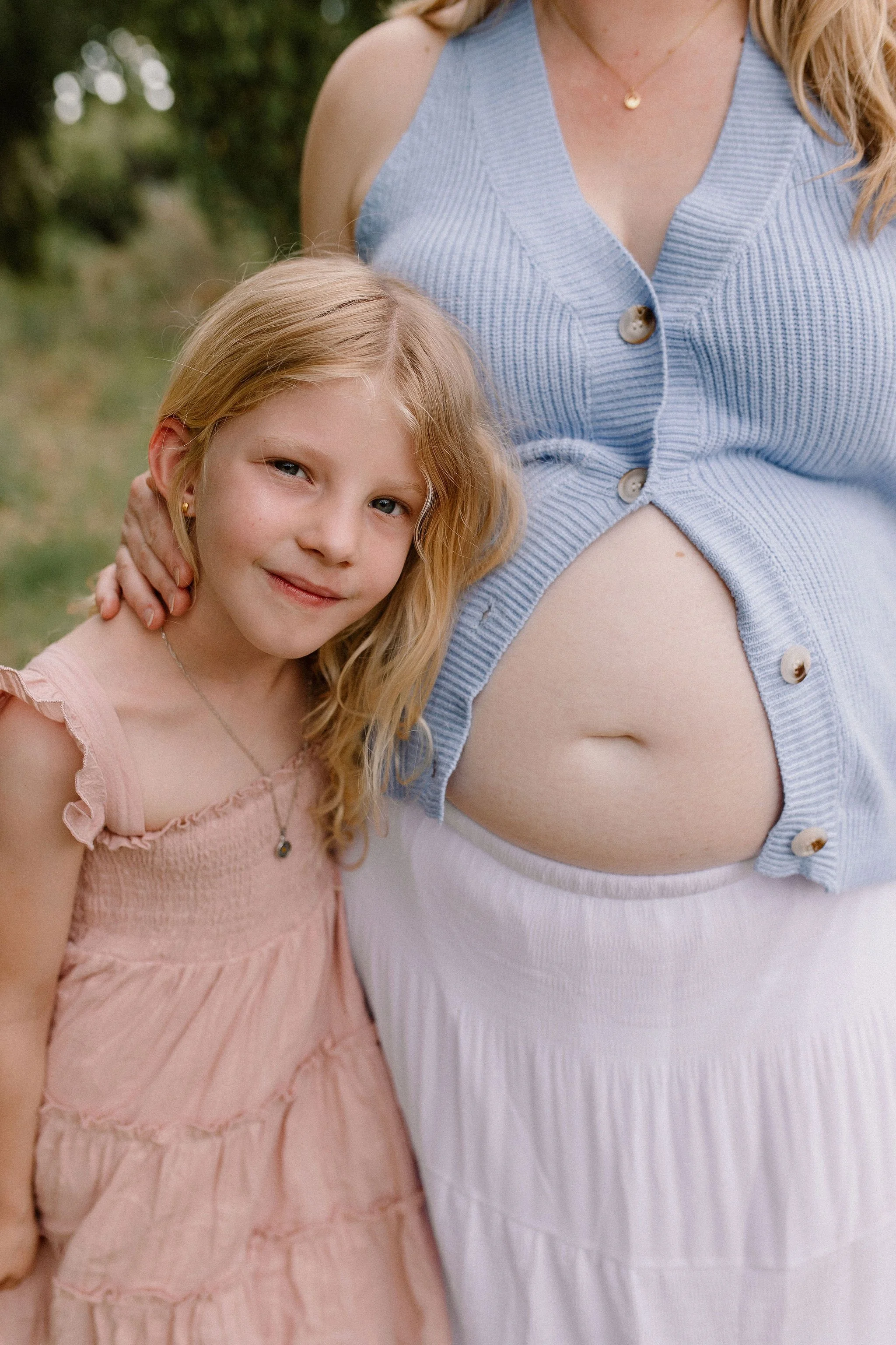toddler cuddling with pregnant mom belly in Mesa maternity photo session