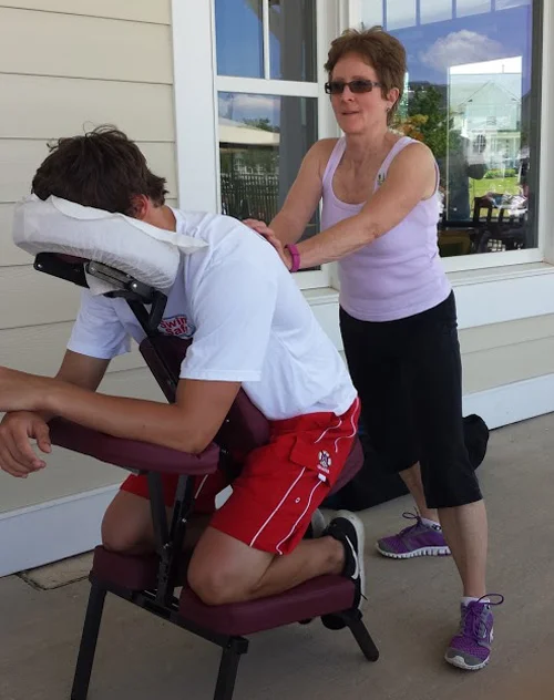 UVS volunteer Laura Balun provides a chair massage during a Memorial Day event