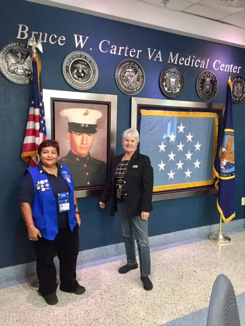 Pictured here (click photo to enlarge) is Maria Lacayo VAVS Rep. at the Miami VA Medical Center and Georgie Krell past National President for the American Goldstar Mothers. The Miami VA Medical Center is named after Georgie Krell son Bruce W Carter who was killed in action during the Vietnam War. He was posthumously awarded the Medal of Honor for his heroism. Mrs. Krell is training volunteers to work at the greeter/information desk.