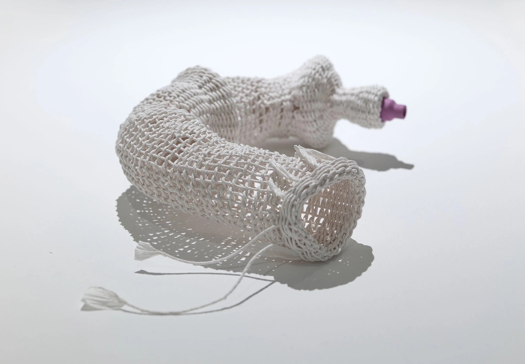 Title: INT/EXT 1(b) view b
2025
Dimensions: H4” x W13” x D4”
Description: paper cord, ceramic, twinning technique
INT/EXT explores the boundary between inside and outside through small, body-like abstract forms. Each piece holds a smooth lavender cer