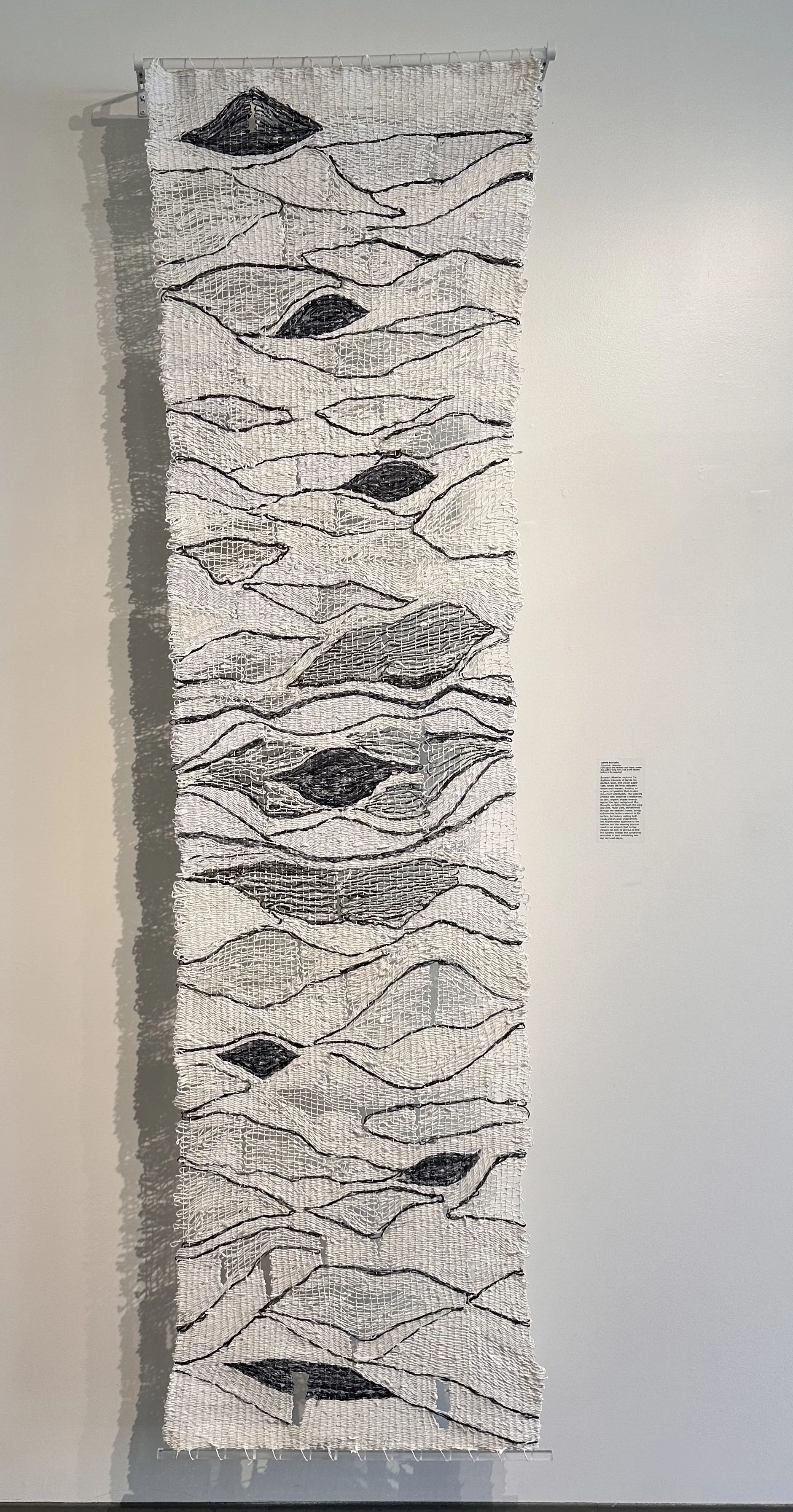 Eccentric Meander
2024
96” x 27” x 3”
hand spun kozo paper, ink, weaving
Eccentric Meander explores the interplay between material, form, and light through the deliberate pace of hand weaving. Building the woven form one yarn at a time reveals weavin