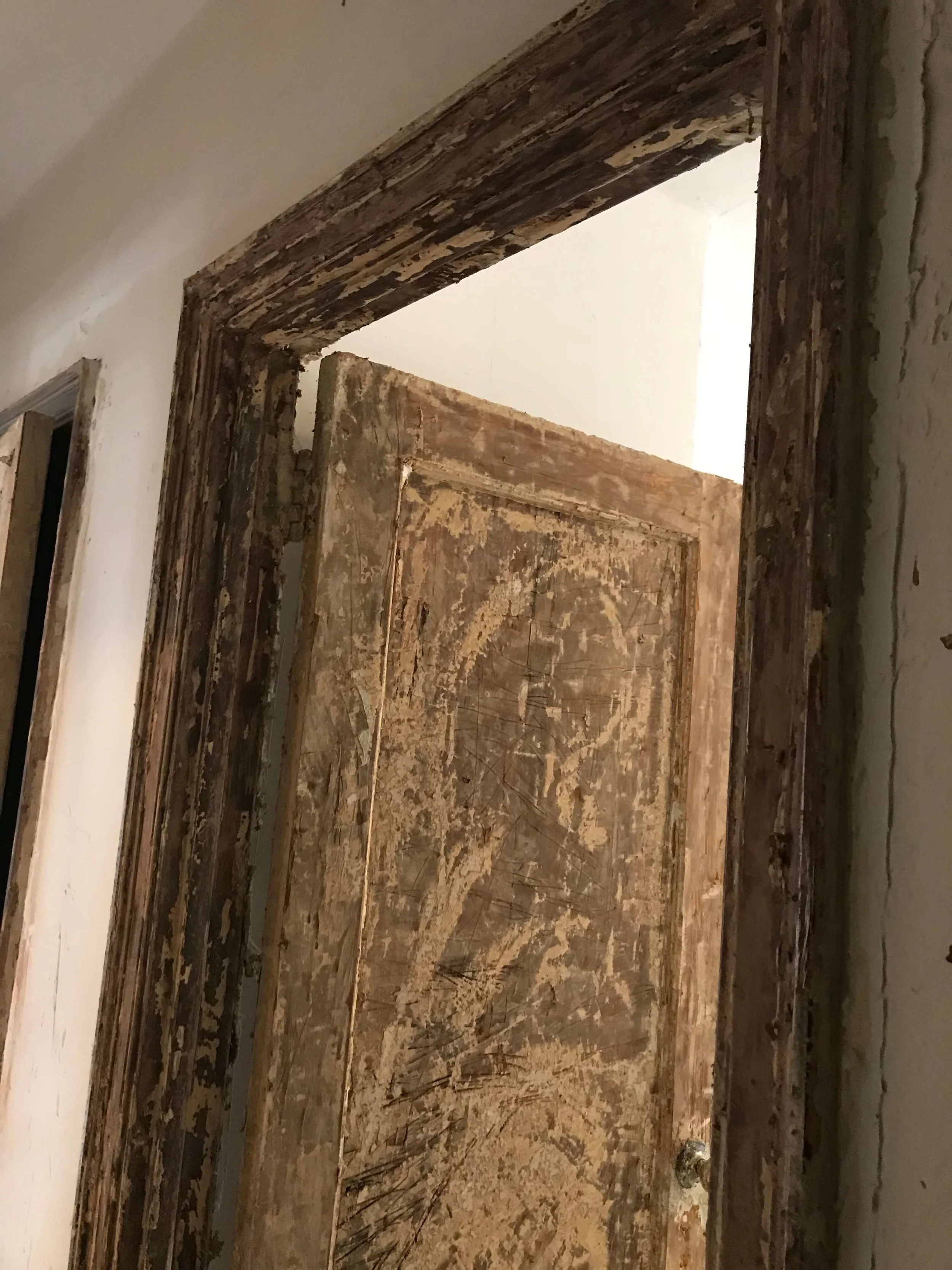 Door and frame in the middle of the stripping process