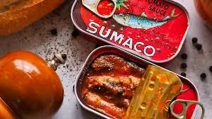A close up of tins of sardines, one half open revealing the fish inside.