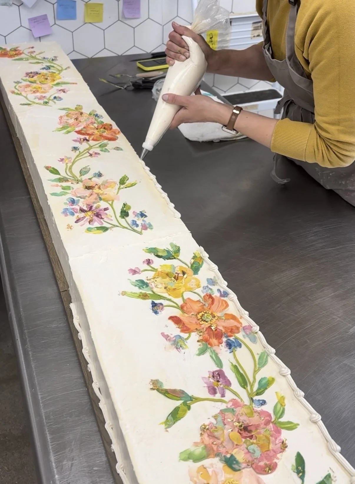 Heather working on long cake.jpg