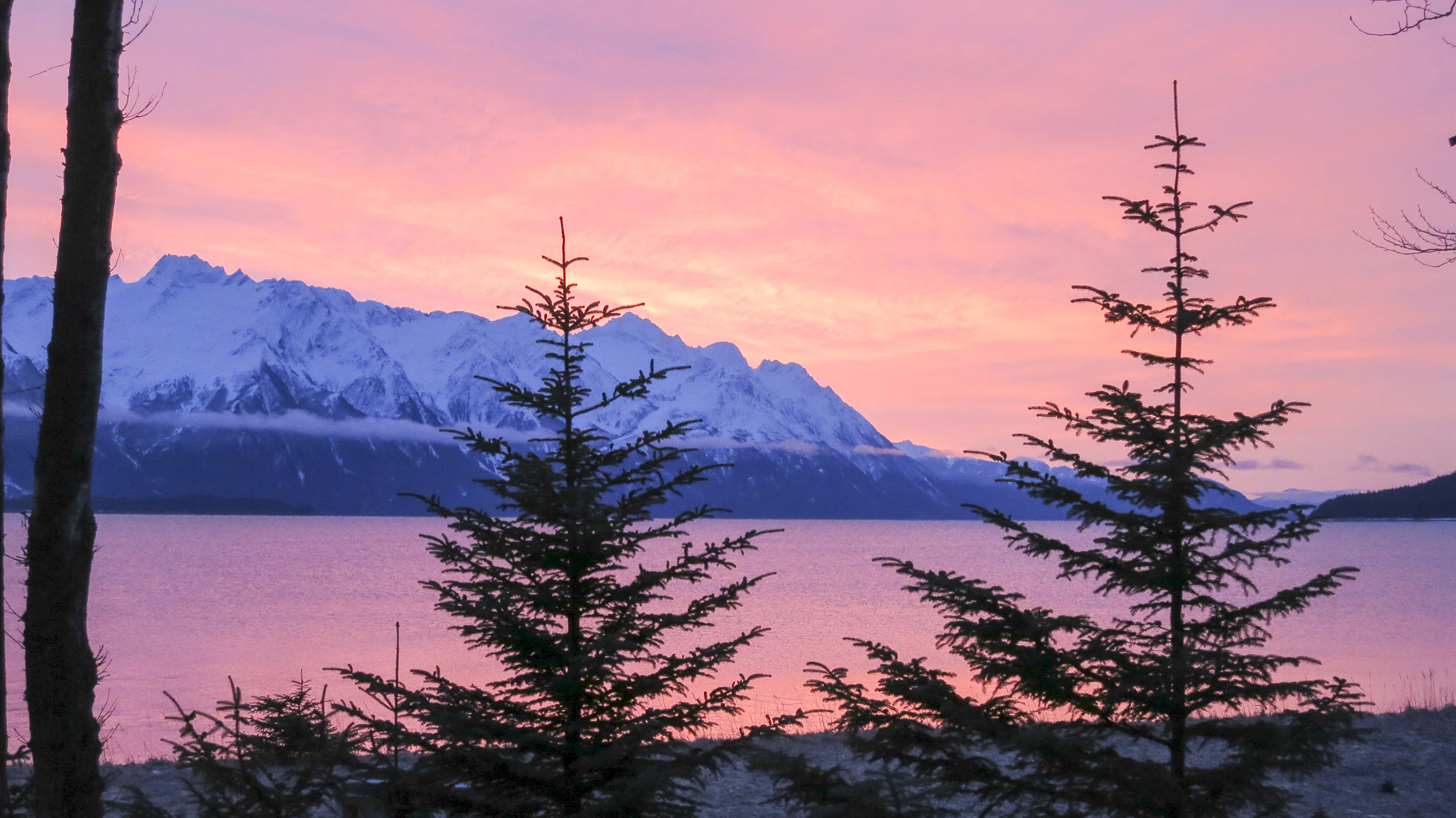 Sunset view of the beautiful and serene inlet as seen from Off the Grid Haines Cabin by Farrell Homebuilding LLC