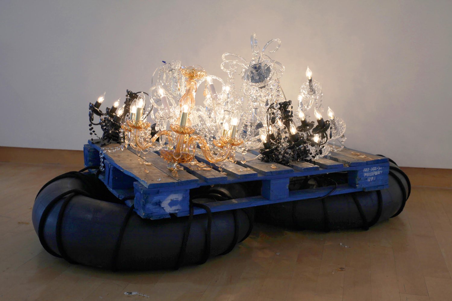    Fathom   2017 Installation with 6 chandeliers, rubber inner tubes, wooden pallets.  Variable dimensions 