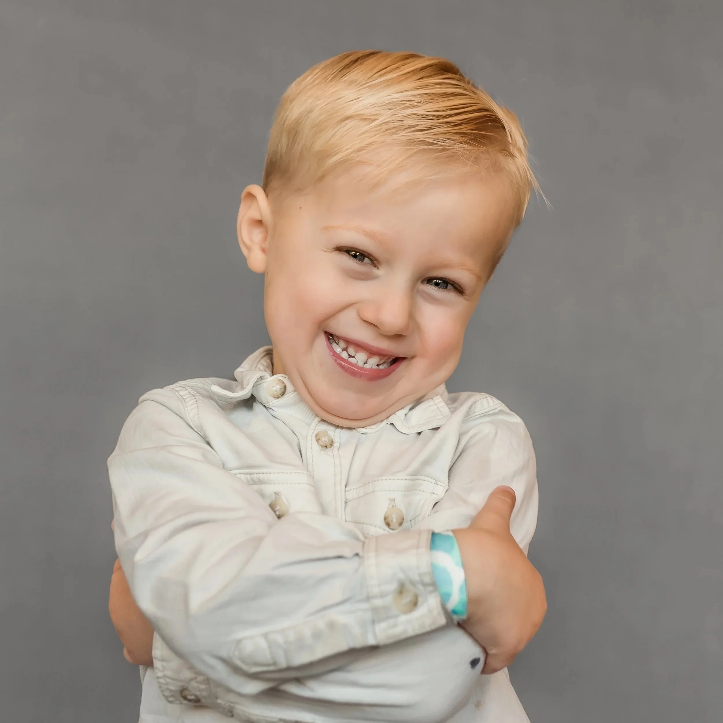 Seattle area personality school portrait of a toddler smiling naturally on a neutral background