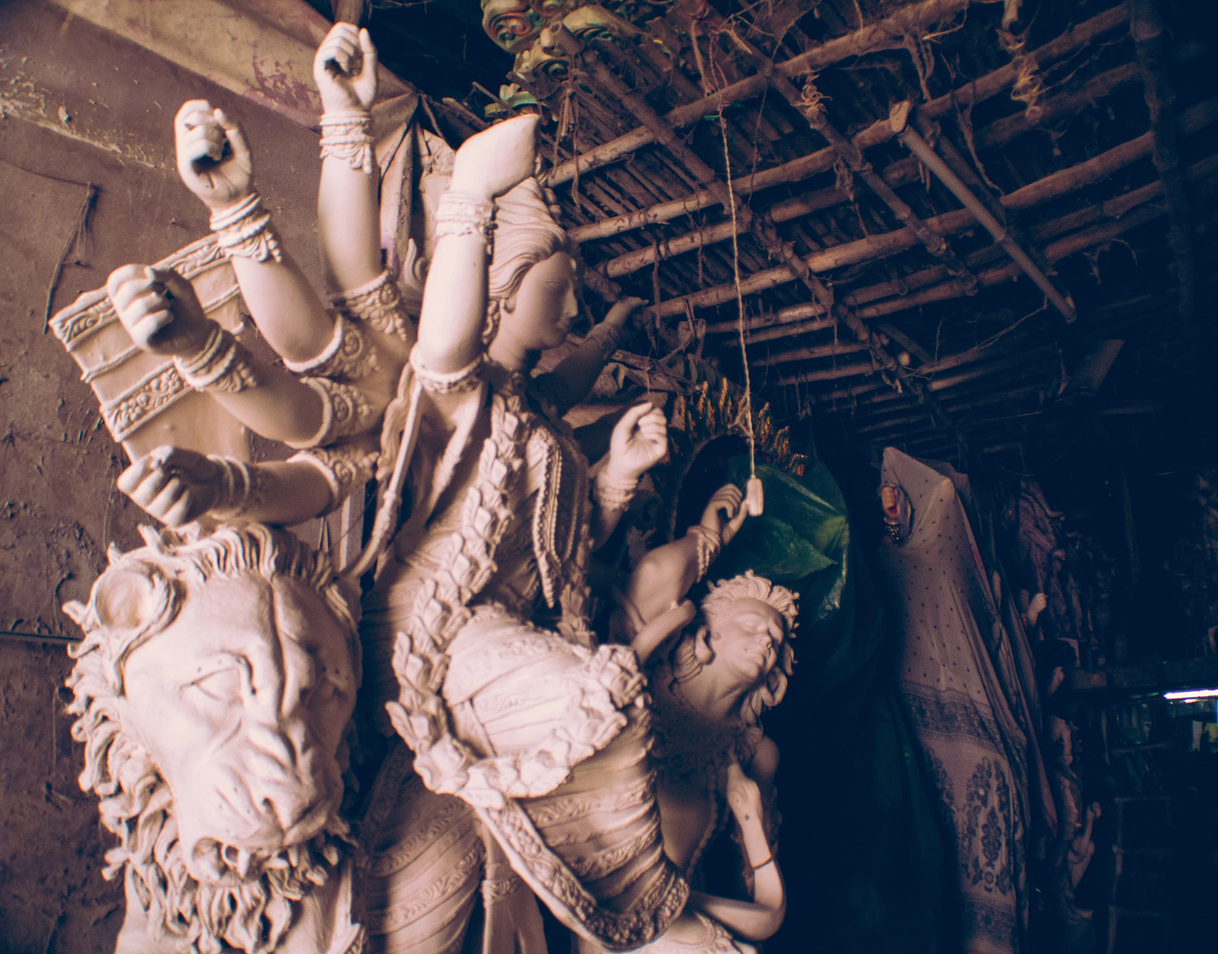A partially finished sculpture awaits her finishing touches inside an artist's warehouse in Kumartuli, days before the start of the festival.