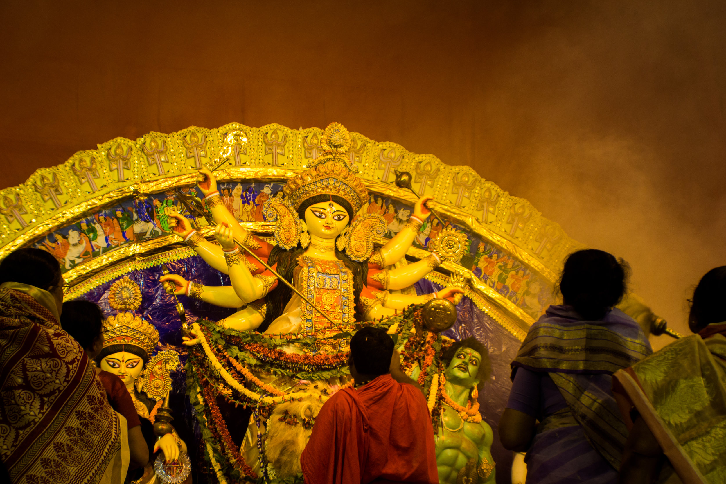  Devotees watch as a priest conducts ceremonial rituals at Kalyan Chakra Club. 