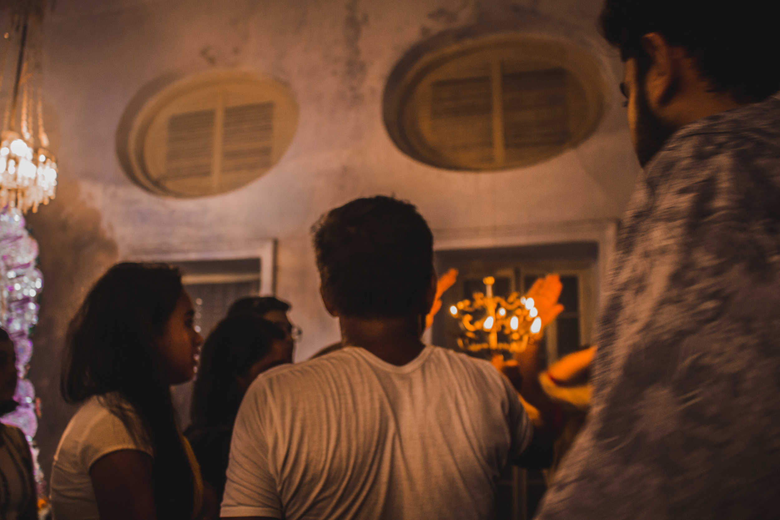  Visitors seek blessing from the flames after  arati, &nbsp;a ritual where the idol is worshipped with the flames from a lamp. 