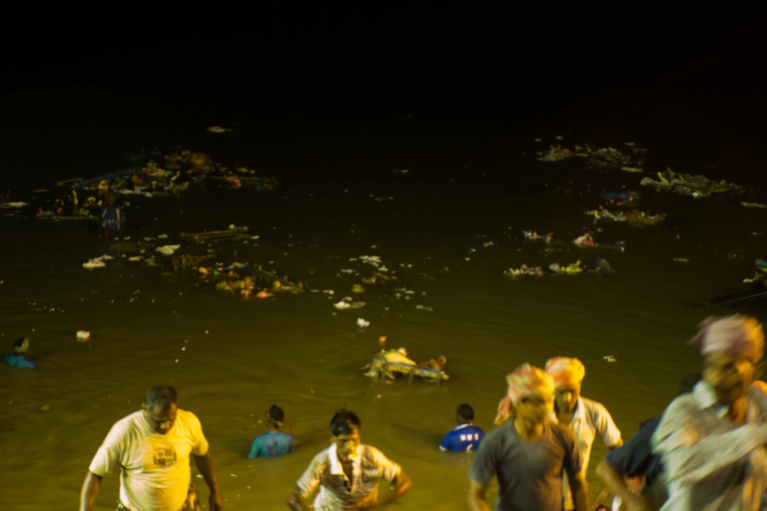 Once the idol sinks into the water, the clay disintegrates, leaving behind a trail of old garlands and ornaments to float along with other debris and waste thrown into the river.