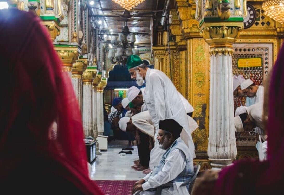 Men kneel for prayers at Nizamuddin Dargah, a mausoleum built for a prominent Sufi saint Khwaja Nizamuddin Auliya. Hundreds of pilgrims visit this site of worship, daily. The Dargah is also famous for Qawwali, a type of religious music session. And t