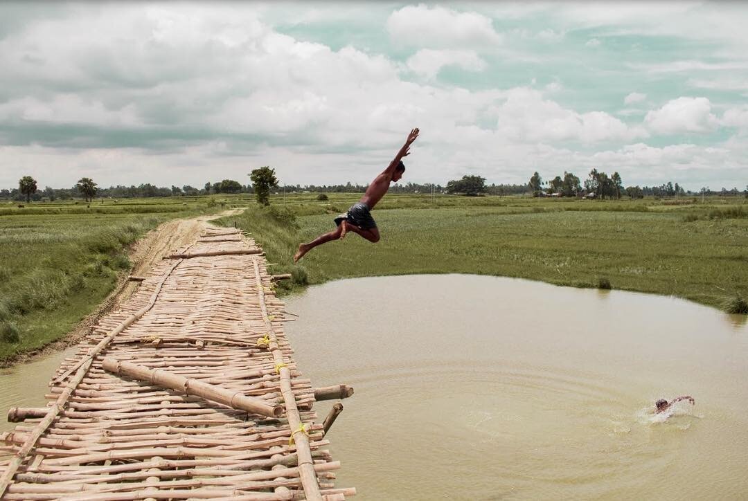 In 2017, the rural district of Malda experienced a devastating flood. Many watched their homes, their cattle, and their crops float away before their eyes. The wooden bridge seen here was built during the floods, so villagers could move to dry land.
