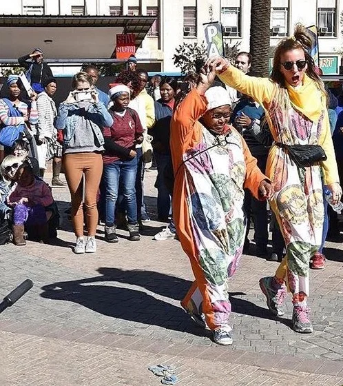 Image: Adele Varcoe and a Onesie recipient at Vrystaat Arts Festival (2017). Photograph courtesy of Vrystaat Arts Festival.