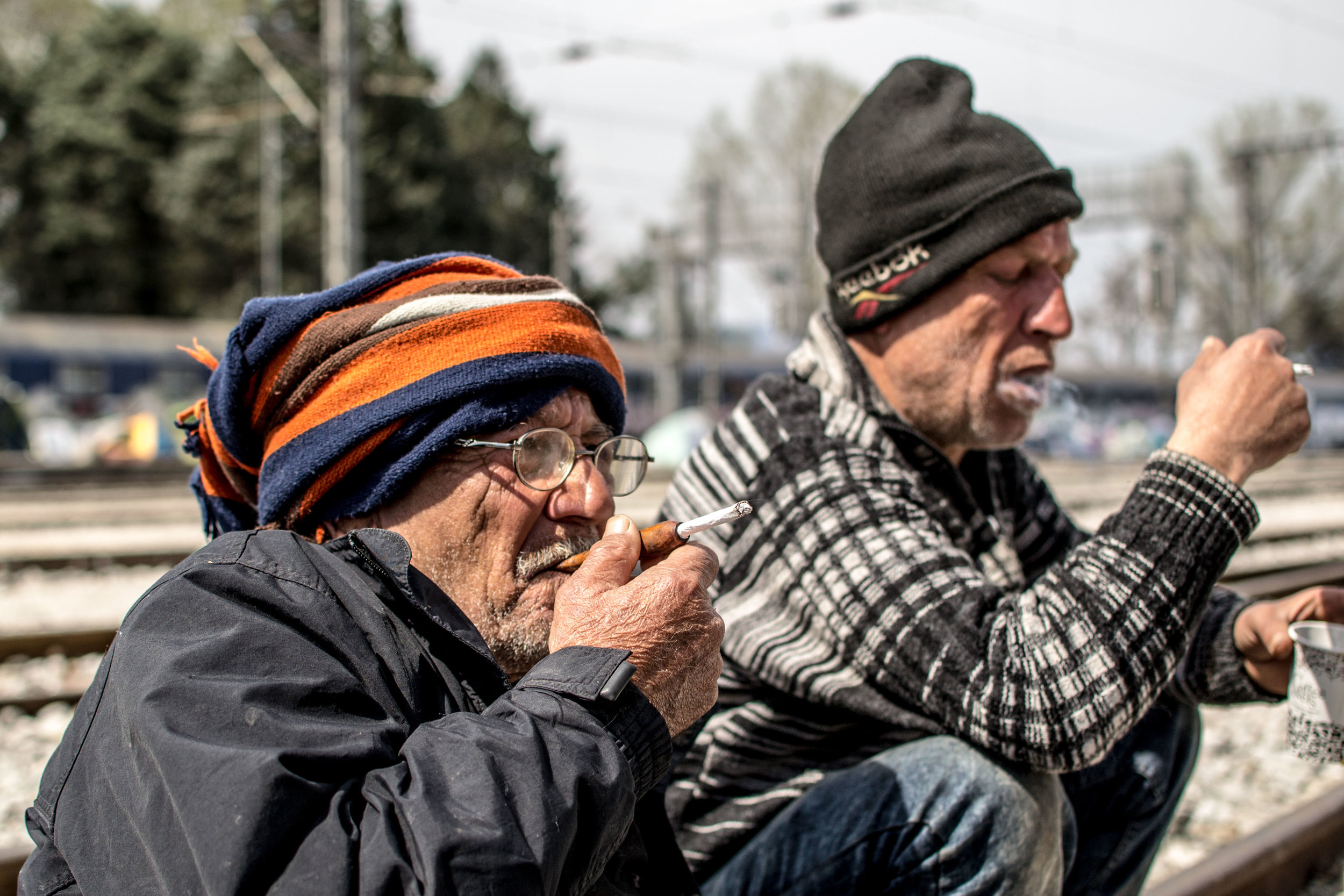 Two Afghan men sit smoking, with a large bag of tobacco beside them. Outside of the camp were savvy salesmen, with large bags of cigarettes. I'm not sure whether they were selling them legally (taxed), but whenever the police were present, they were