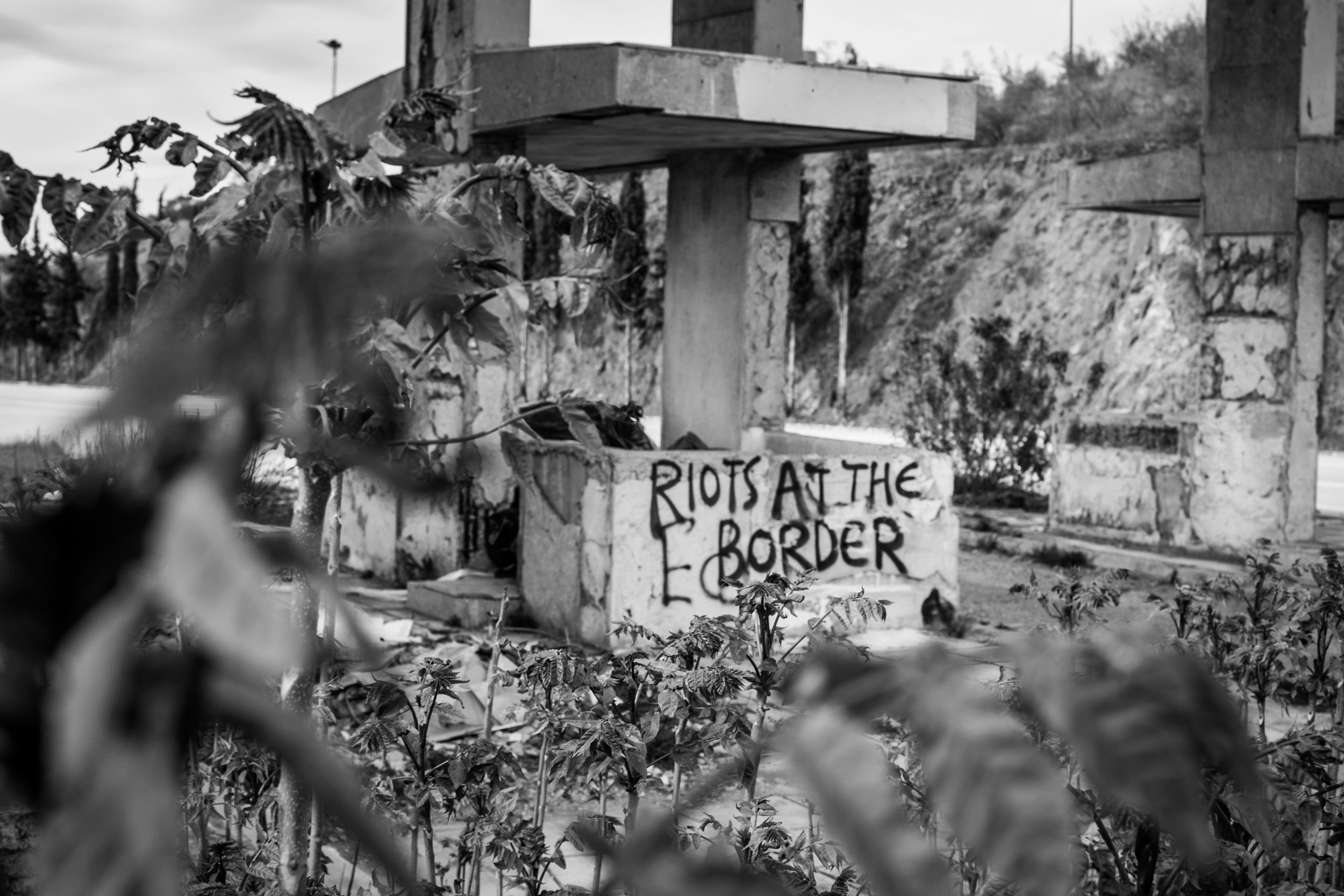 Graffiti on a road near Eidomeni camp. During riots, a mass of refugees invaded the highway, blocking oncoming traffic.