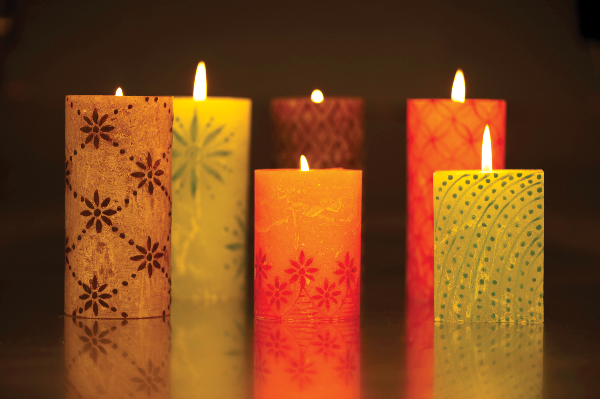 kapula-hand-painted-pillar-candles-lit-flame-glowing.jpg