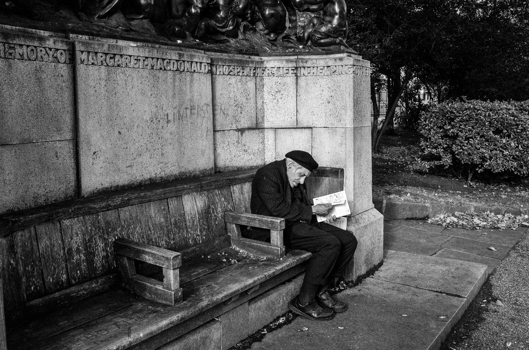 Reader on stony bench