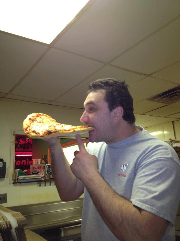 Dino enjoying a jumbo slice of handmade, delicious, real pizza!