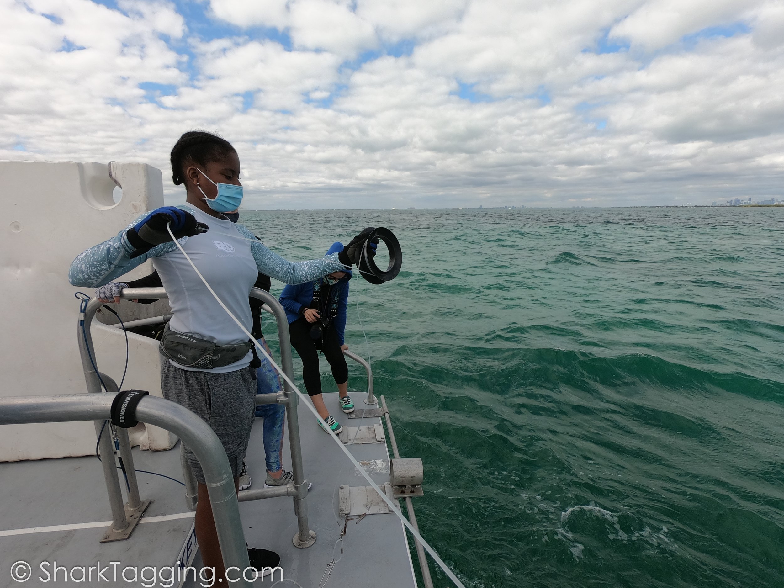 BGD Scholar Alex is checking her shark line to see if anything is at the end.