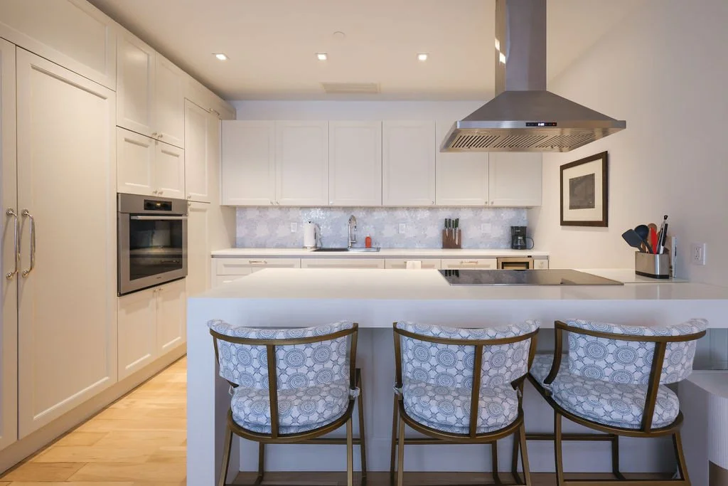 This FiDi kitchen&rsquo;s transformation was all about softening what once felt harsh and dated. New cabinet panels and added island storage with @paintworks were paired with traditional lighting to bring out warmth and character. The inlaid floral b