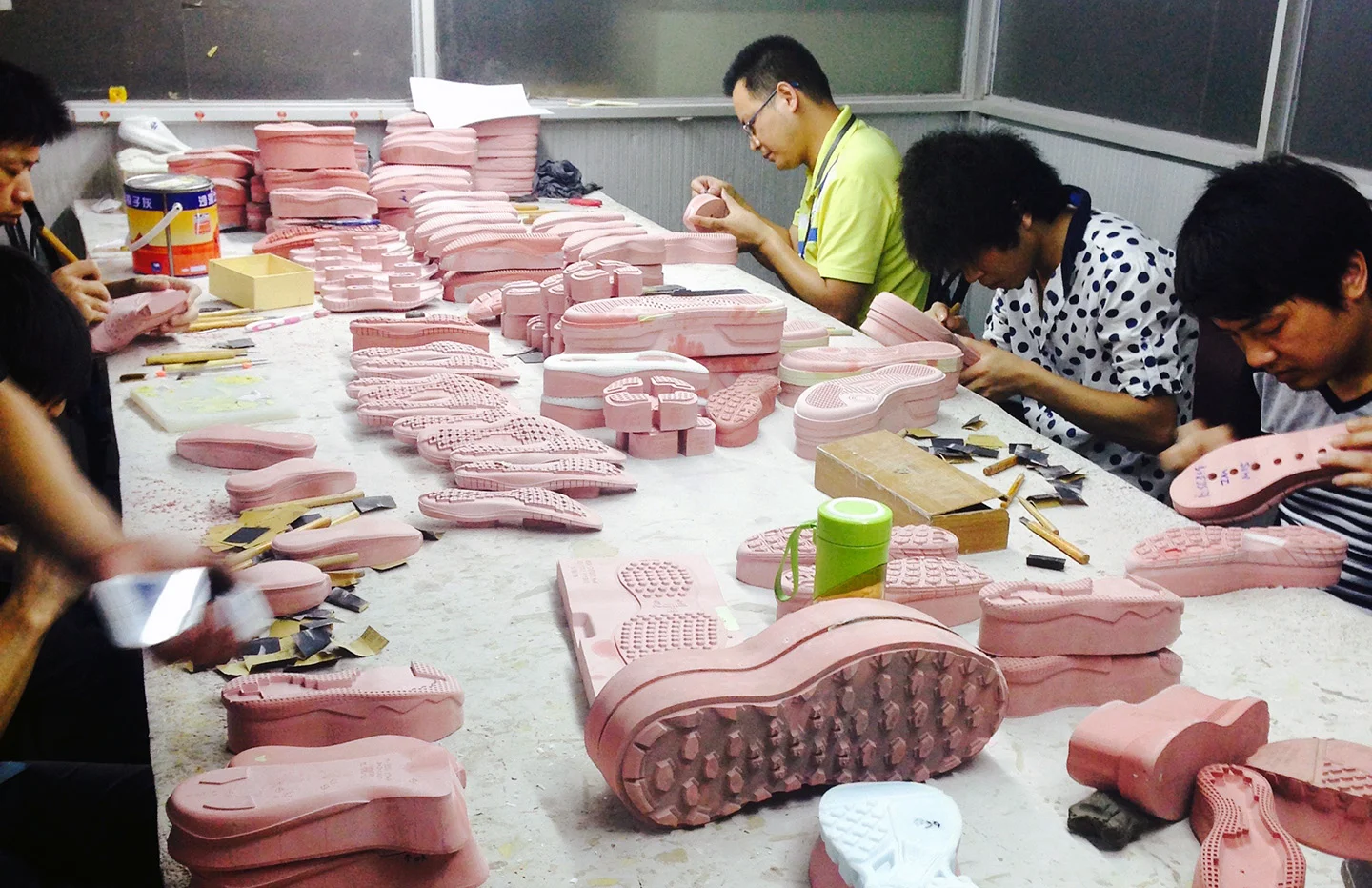 The “red wood” mock up of a sole design is being hand finished by well trained “artists”.