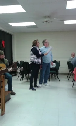 Praise Leader Britta and Pastor Ken Leads in Singing