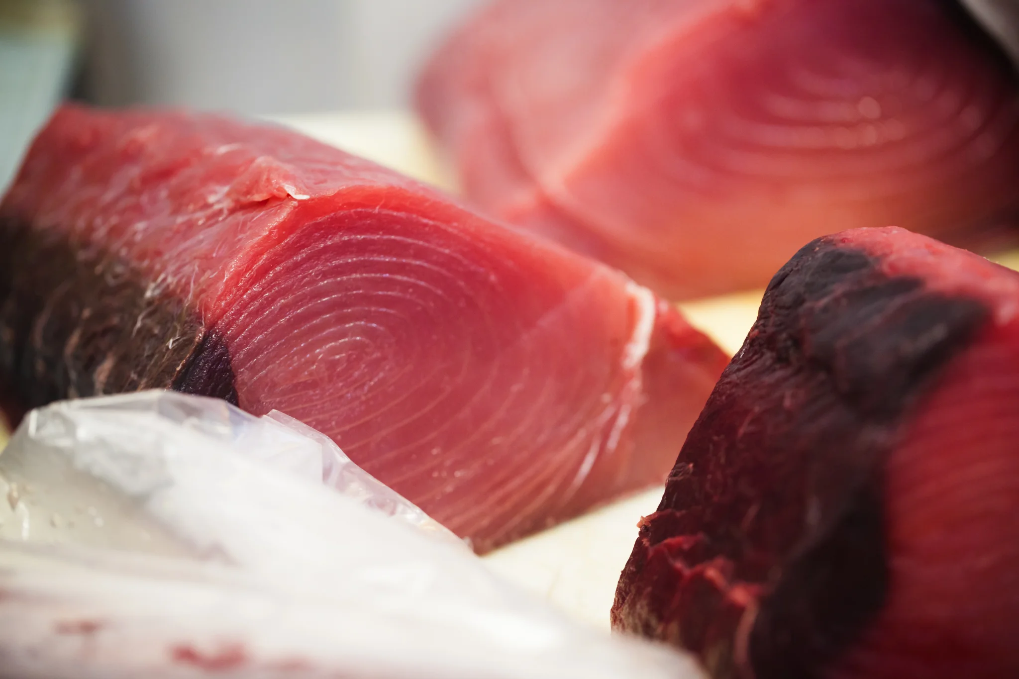 Beautiful tuna loins at our warehouse - the dark portion is the bloodline that is removed just before preparing your recipe. The bloodline and the skin help keep the meat intact and together.