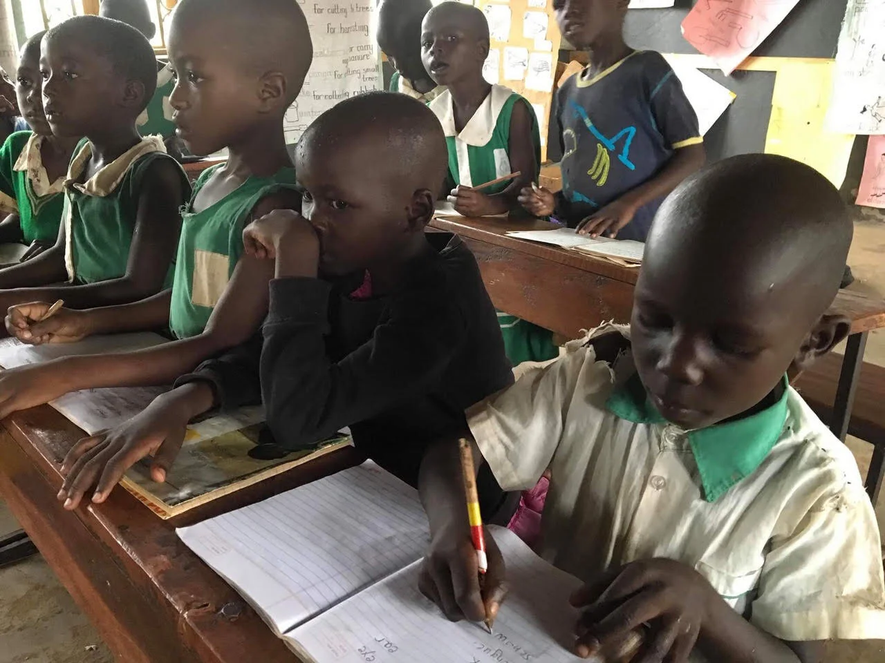 Some precious kiddos working at desks in the new school.