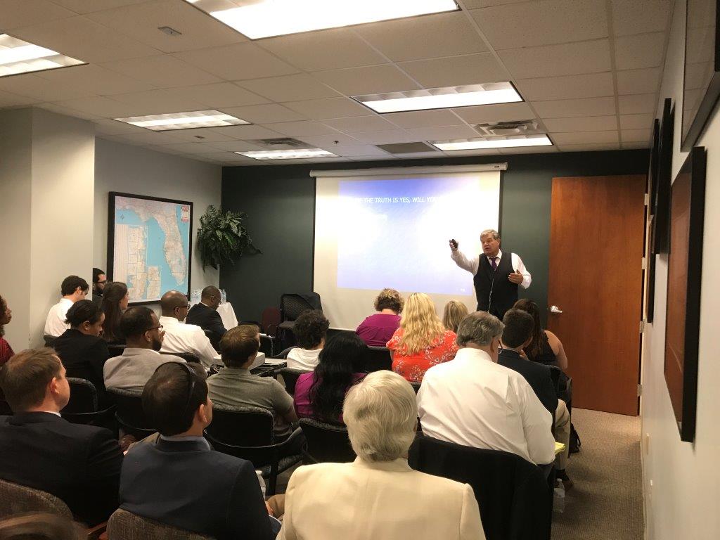 Picture of Roger J. Dodd teaching to a room full of people.