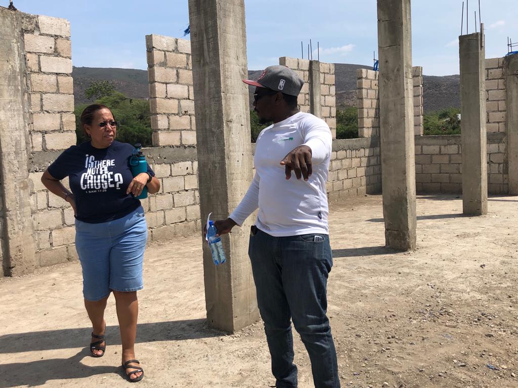 Left: Gemma Malchan-Benny (ITNAC) & Patrick Delice (ECM Director of Operations) finalizing building plans for the school building.