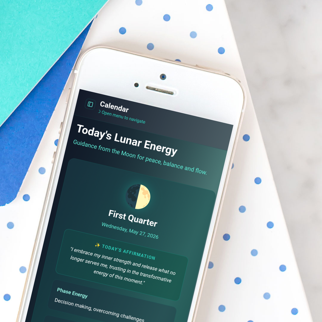 By the Moon app mockup on an iphone screen atop stationery items