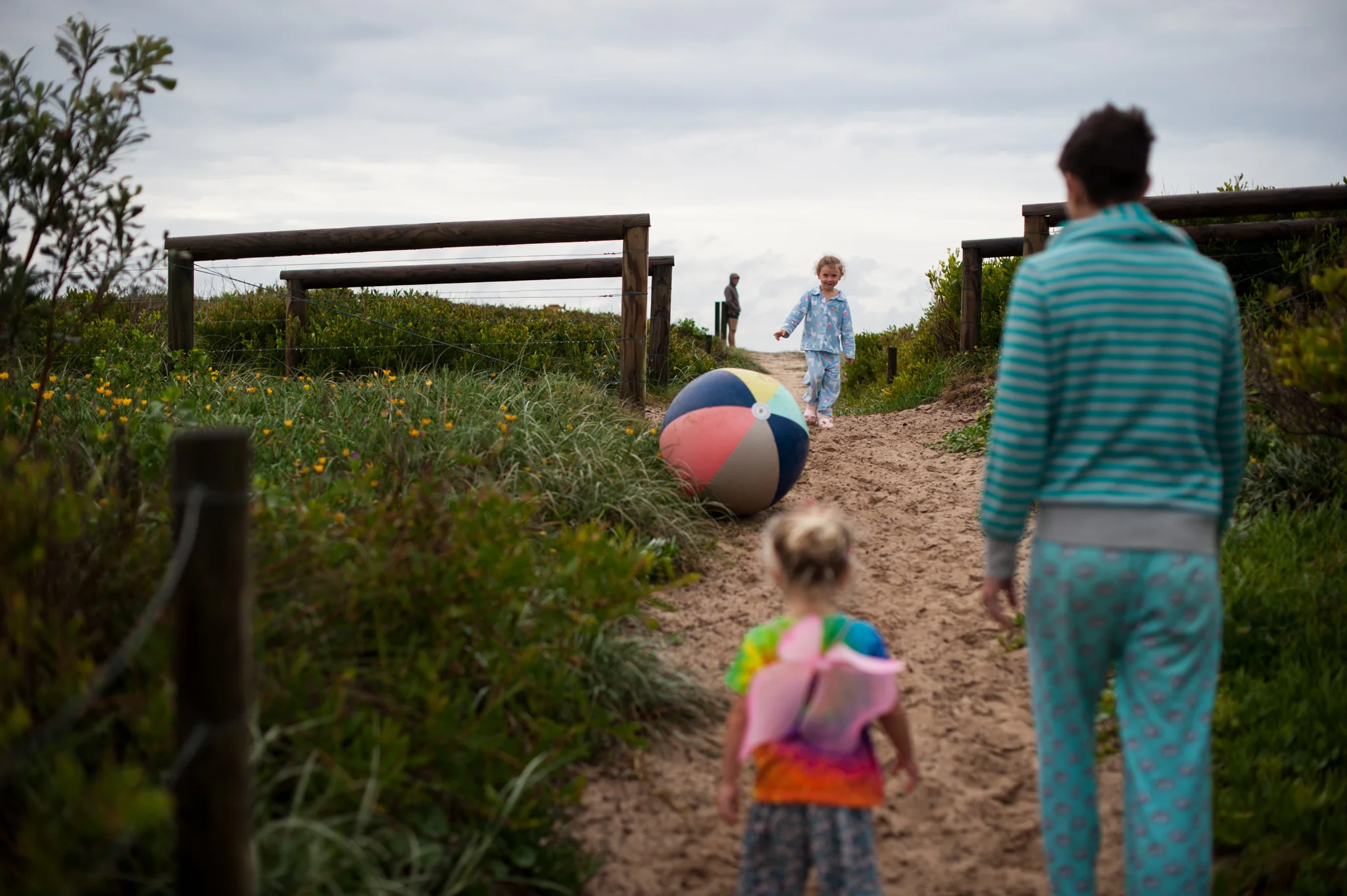 Walking to the beach with colourful beachball