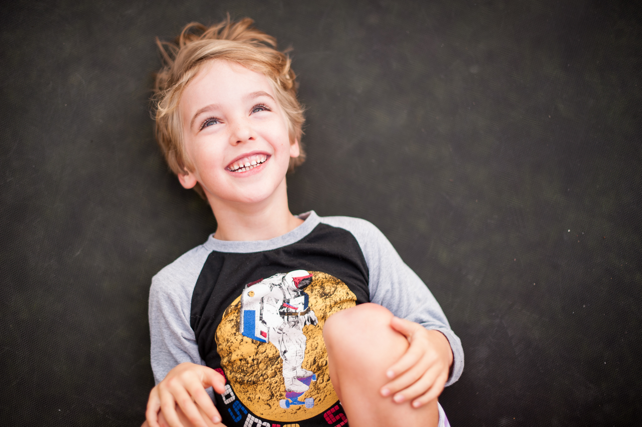 Little boy laughing on trampoline