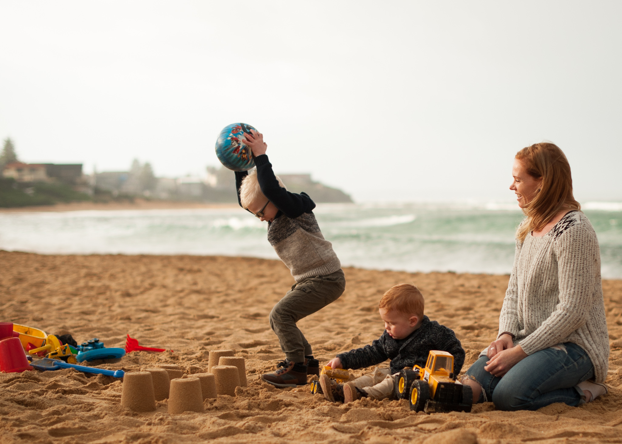 Throwing ball at sandcastles