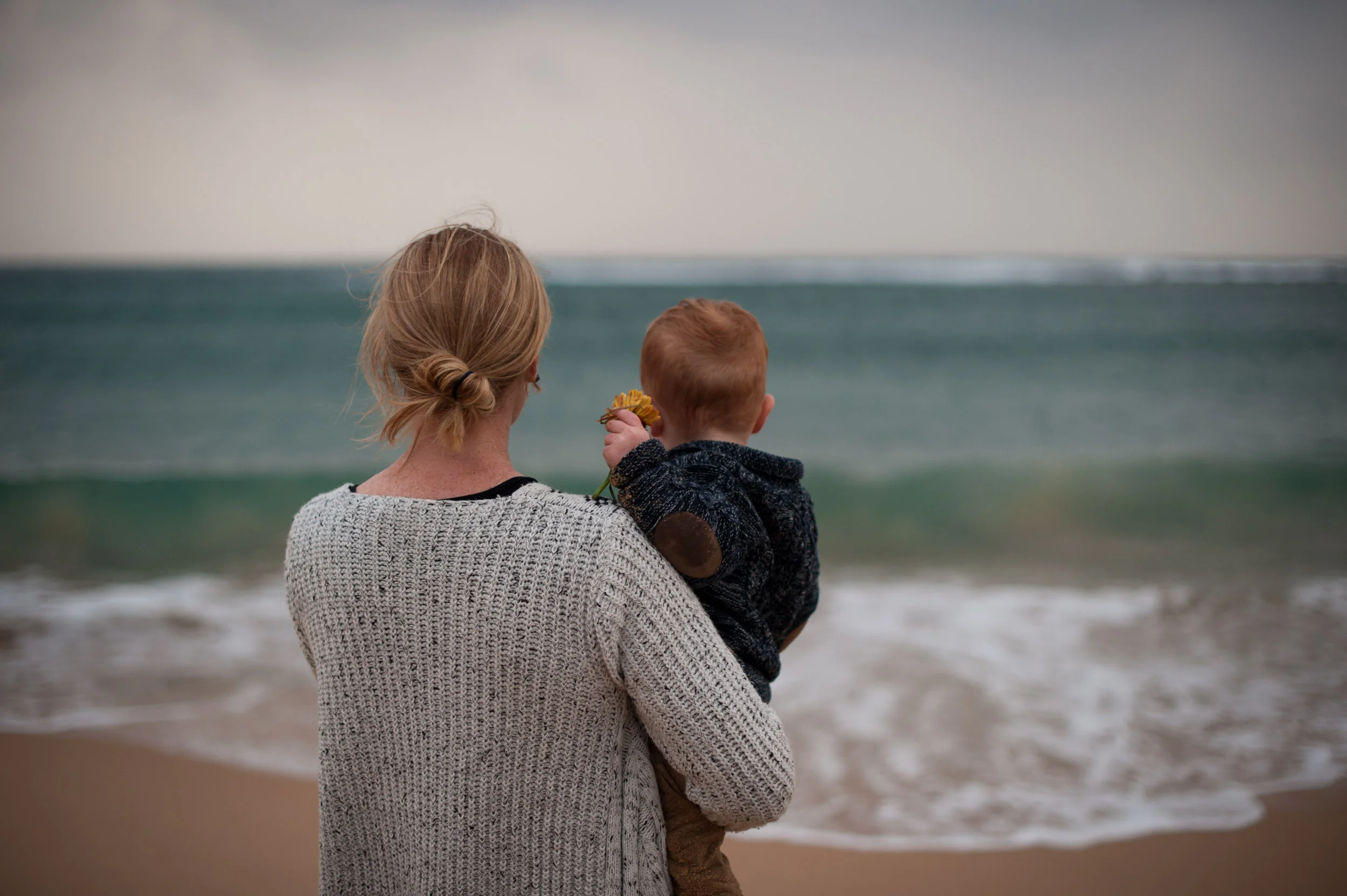 Cuddles with mum watching the waves