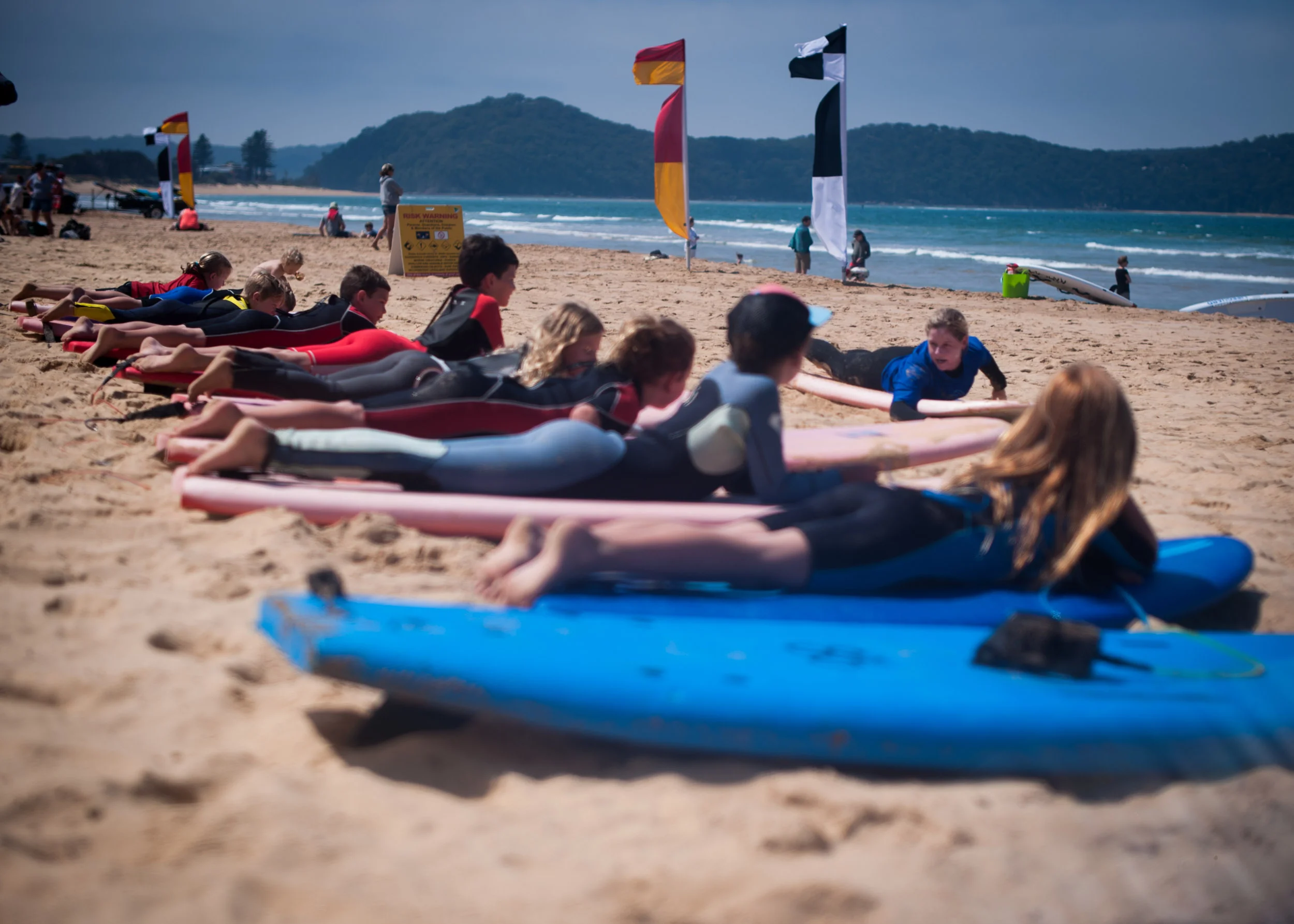 Sal's surf school kids lying on boards Umina Beach Photography Central Coast NSW