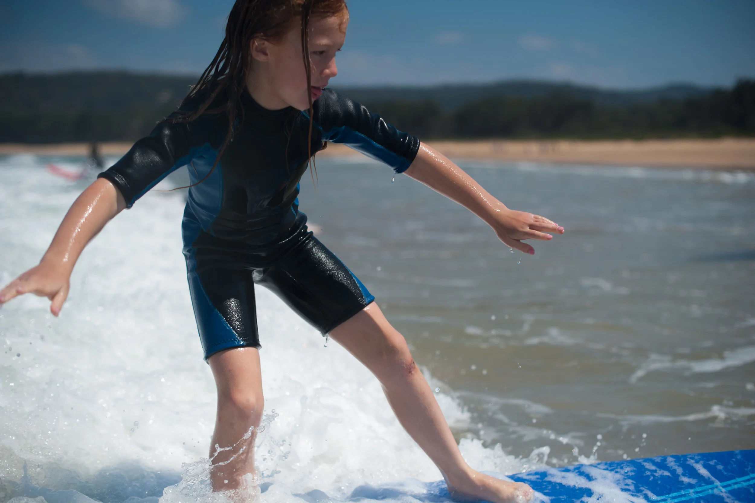 Girl surfing Umina Beach