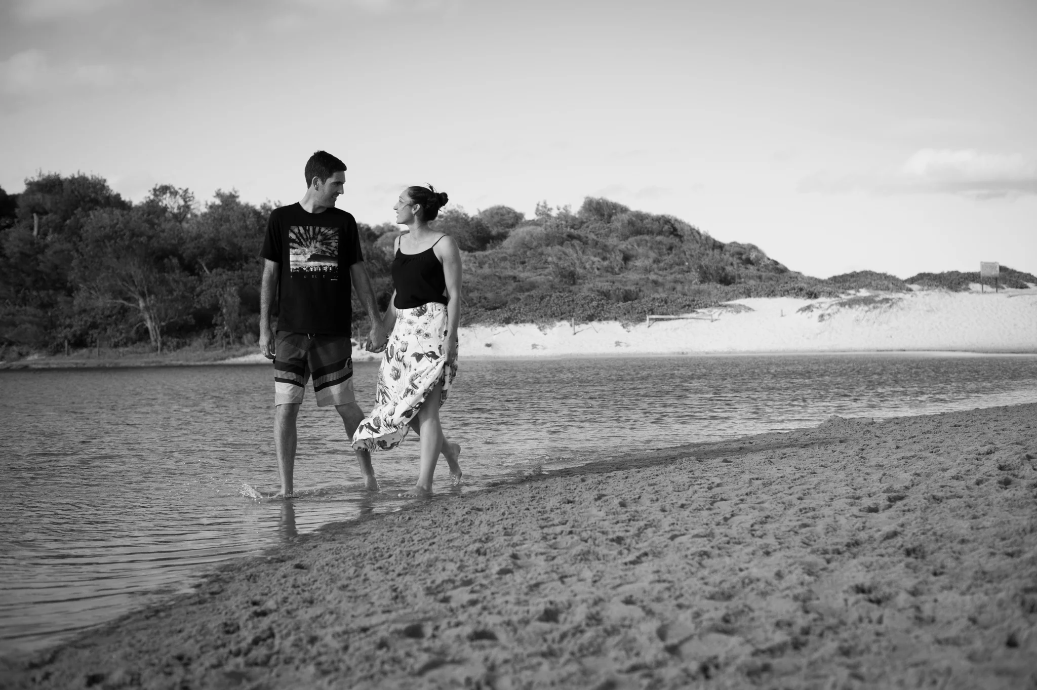 couple walking at wamberal lagoon