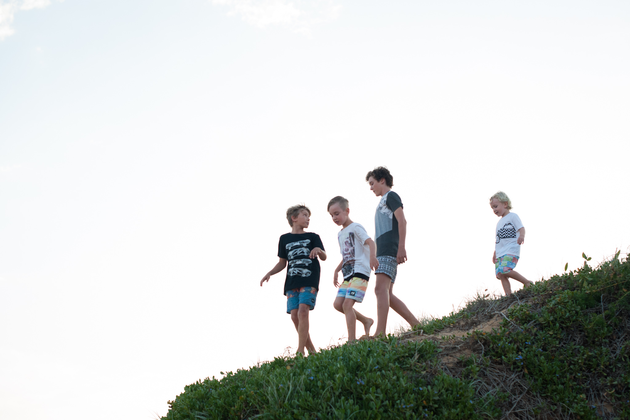central coast family photographer boys playing in sand dunes