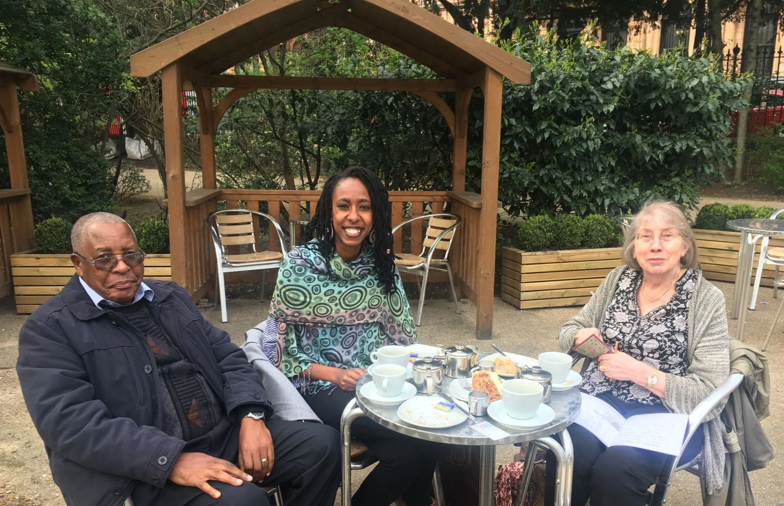 Chao (centre) and Olivia (off camera) talking archives with Nathan Mnjama and Mandy Banton in Russell Square, London. 