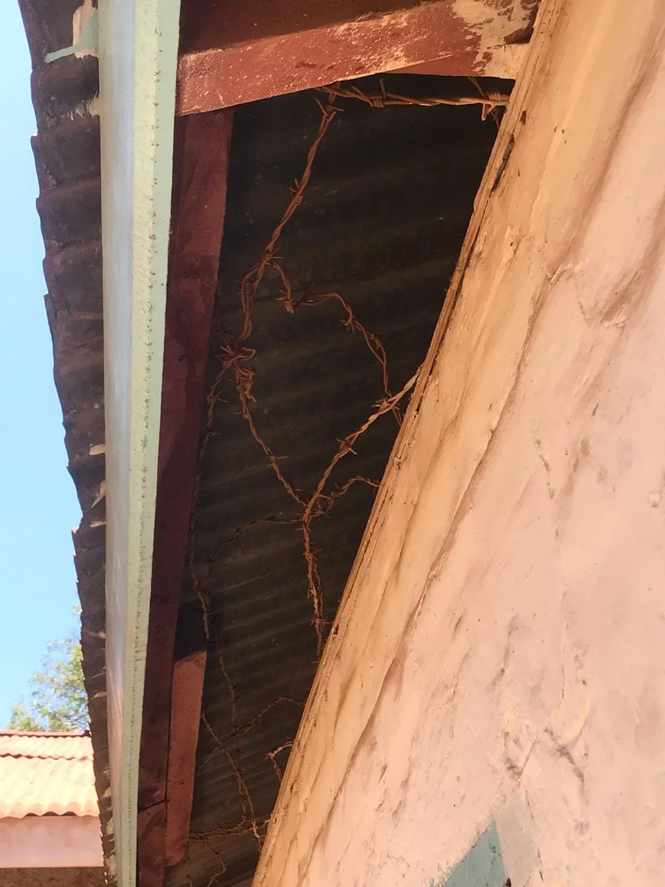 Barbed wire in the roof of the solitary confinement cell pictured above.