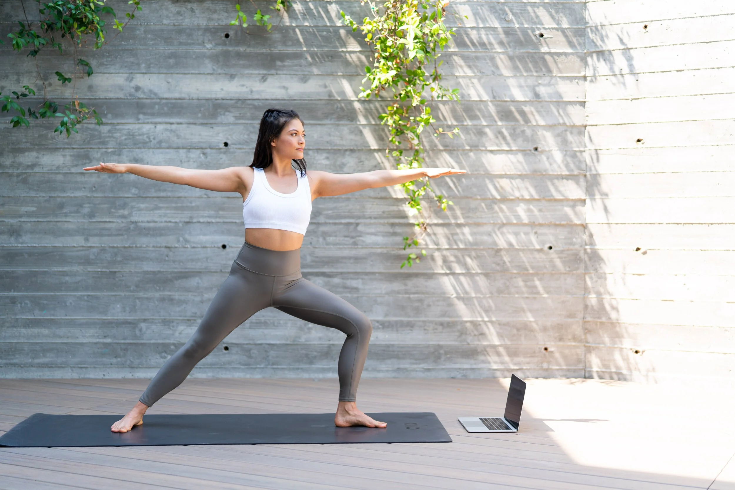 ALO Moves Review: Find Your Perfect Fitness App Woman%2Bin%2Bwarrior%2B2%2Bpose%2Busing%2Ba%2Blaptop%2Bto%2Bpracticer%2BAlo%2BMoves%2Bat%2Bhome